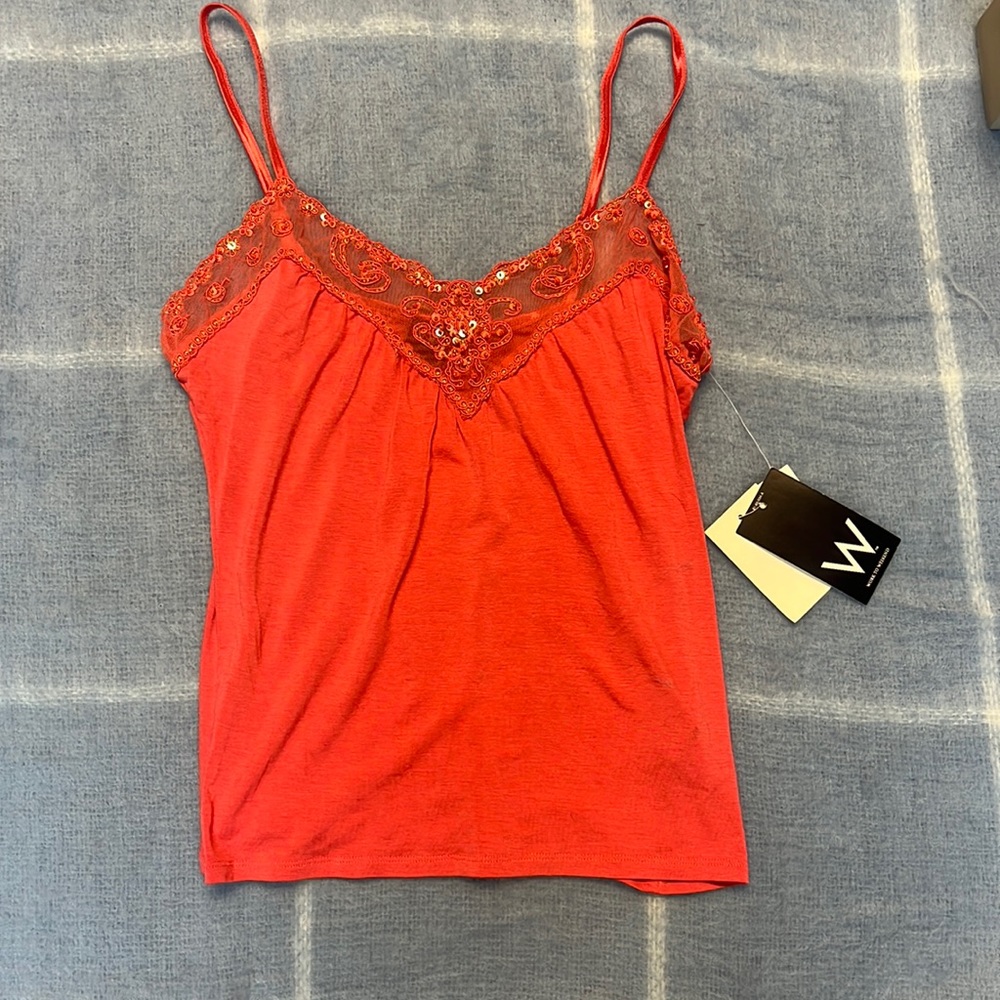 Coral colored tank top with a fancy neckline